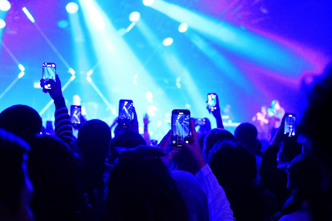 Audience watching smartphones at a concert